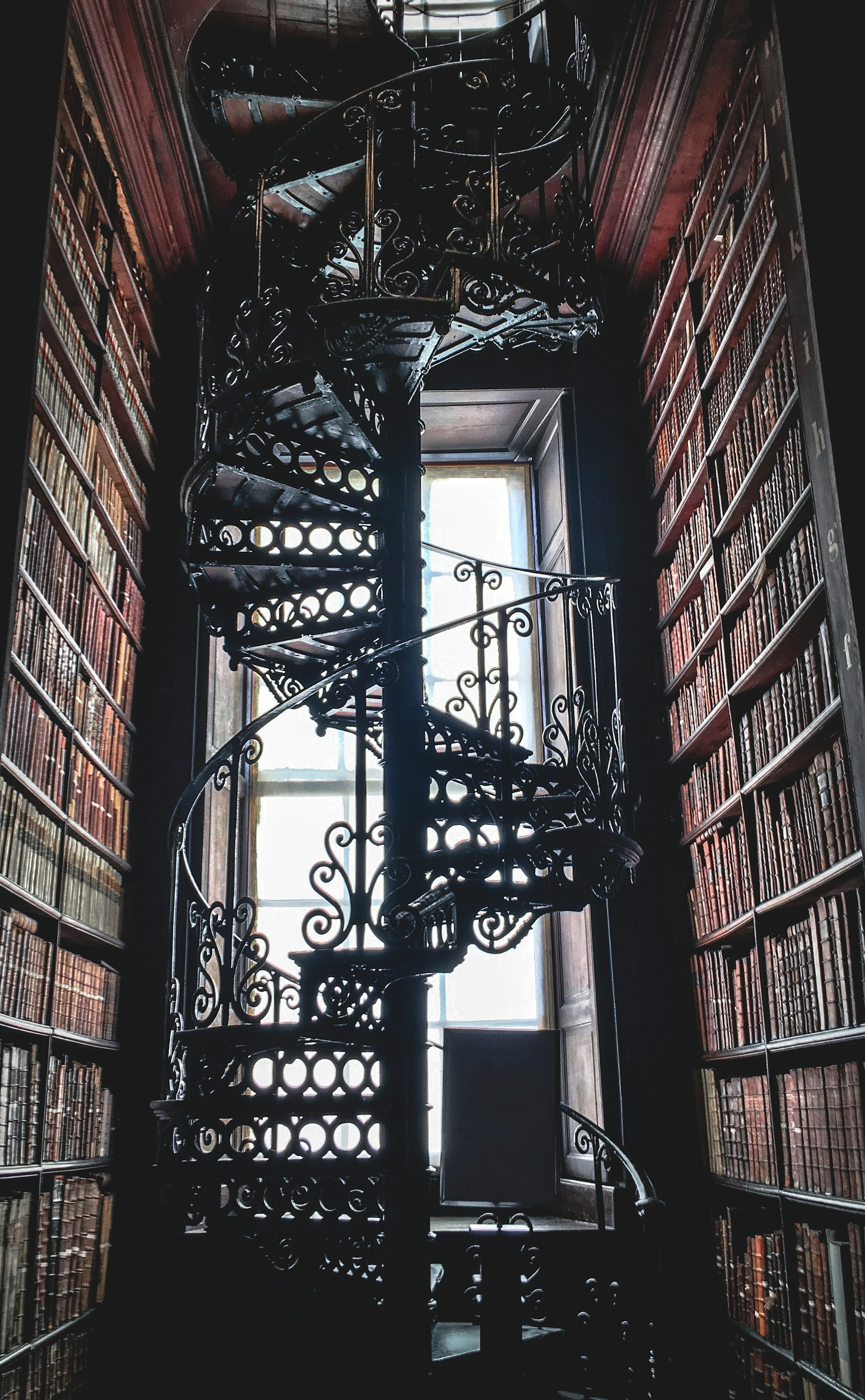 Mysterious staircase in a library, a photo by Kieran-Sheehan at Unsplash